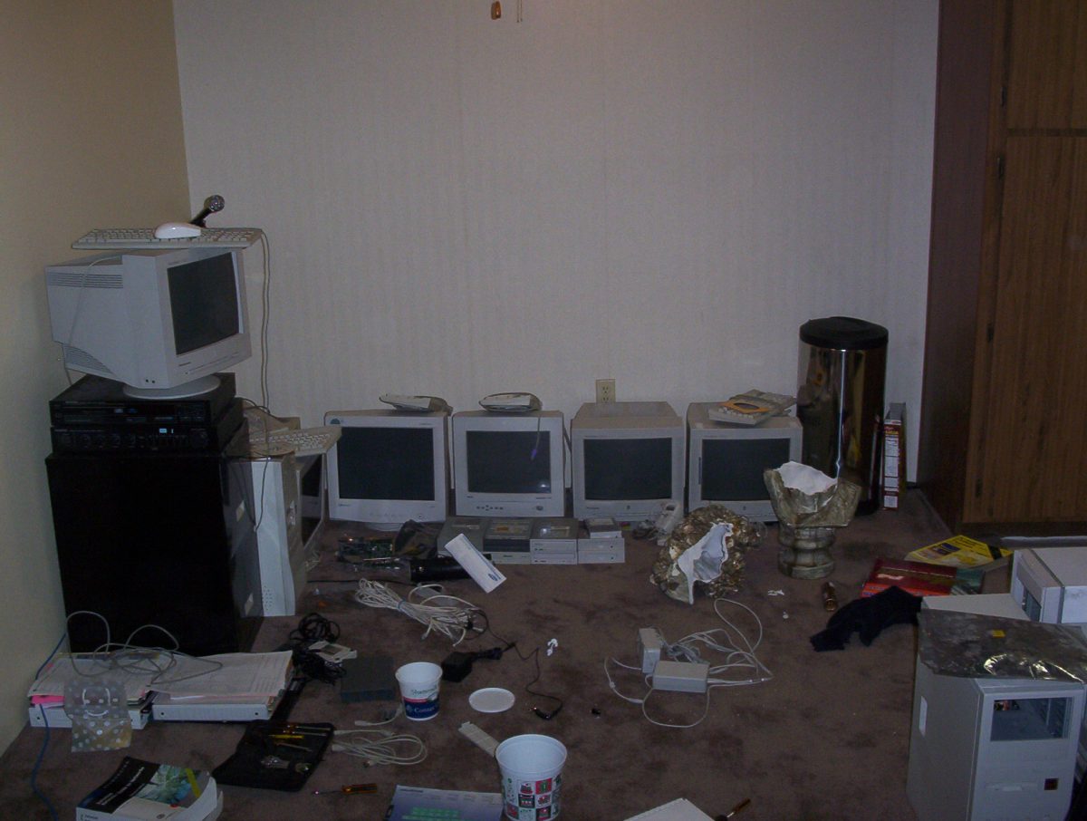 Random old computer parts and monitors on the floor .